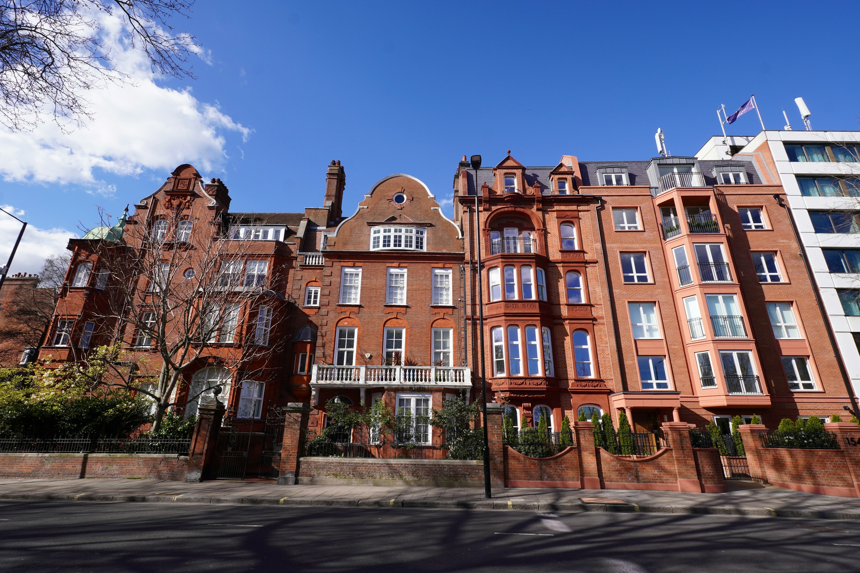 A quiet Kensington street lined with elegant red-brick townhouses.