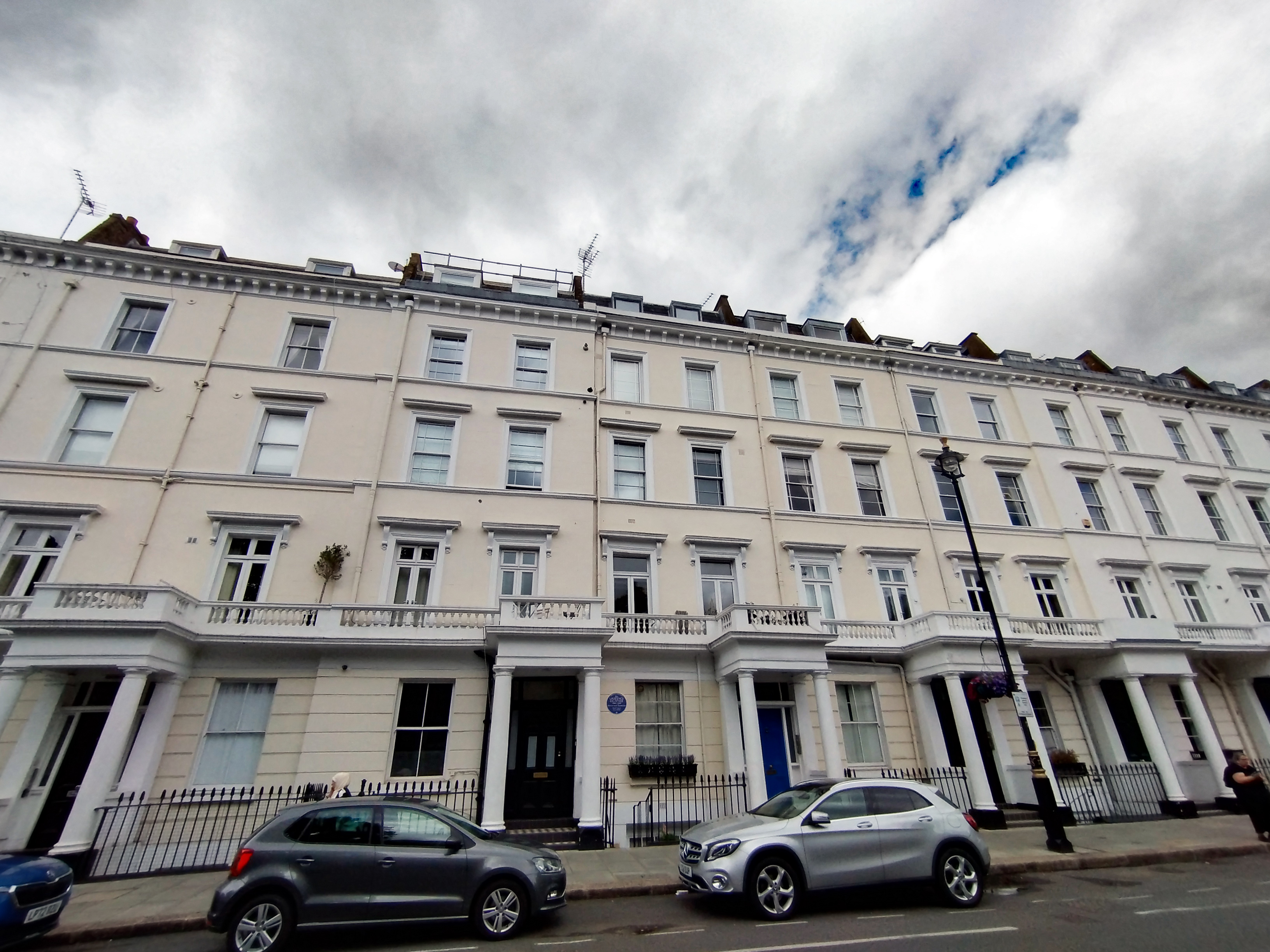 A residential stretch of Lupus Street in Pimlico with terraces and everyday street life.